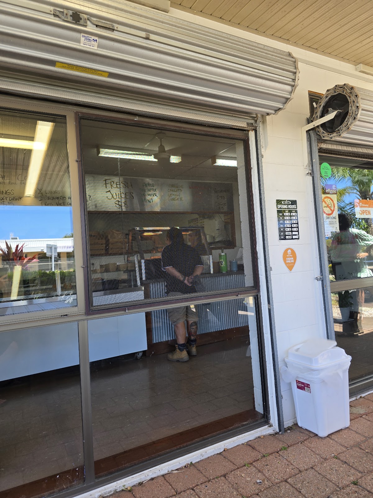 The shop’s serving window with a customer ordering