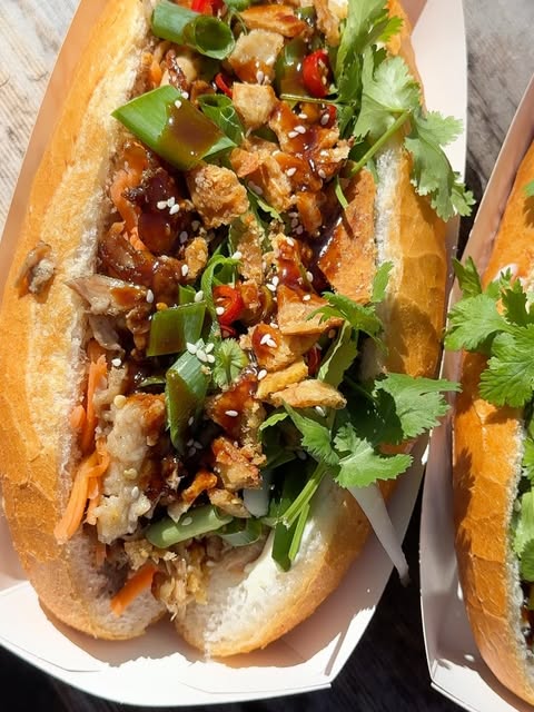 Crispy pork bánh mì with glaze and sesame